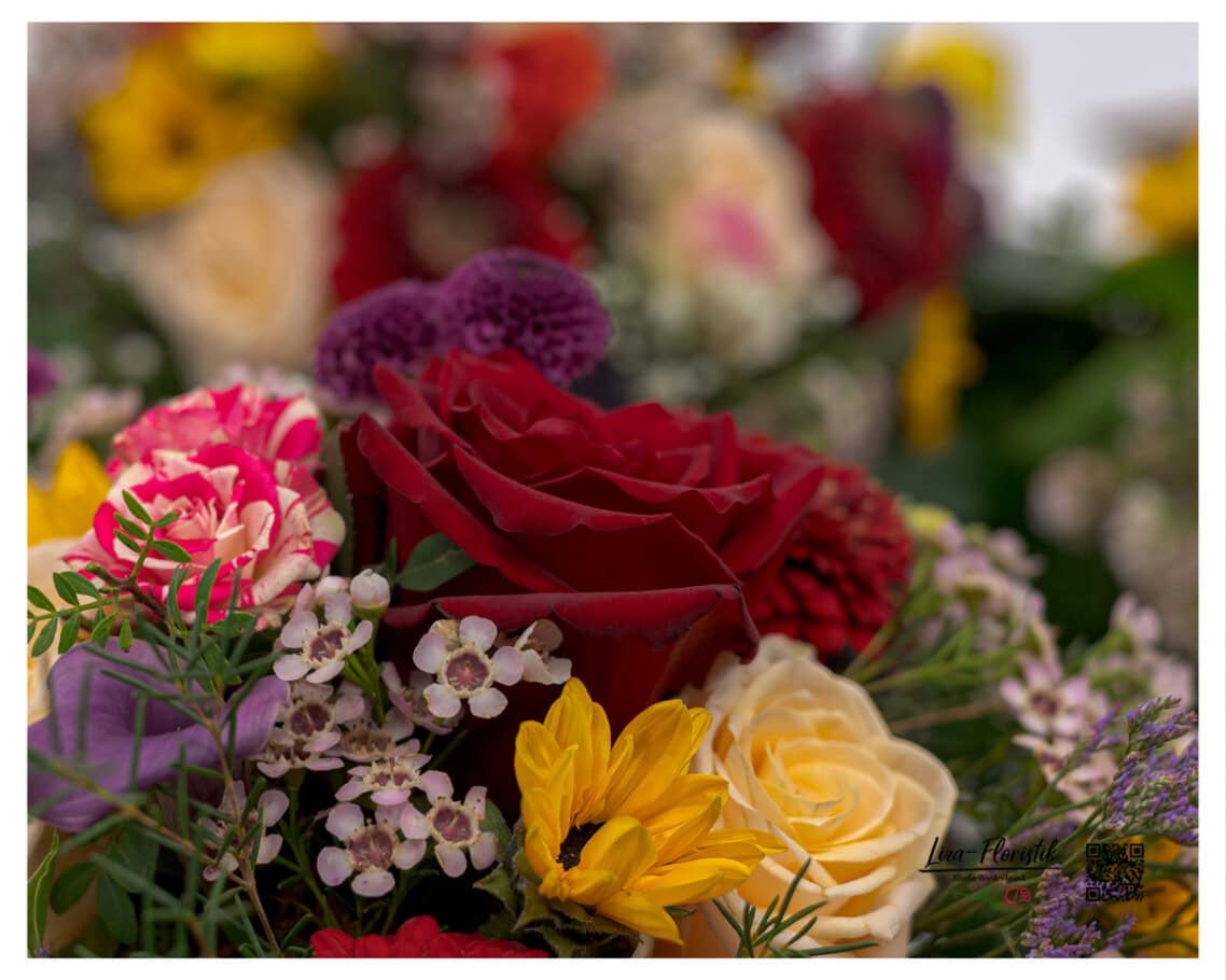 Detailaufnahme – Premium Rosen, Waxflower, Santini und Mini-Sonnenblumen im offenen Trauerkranz