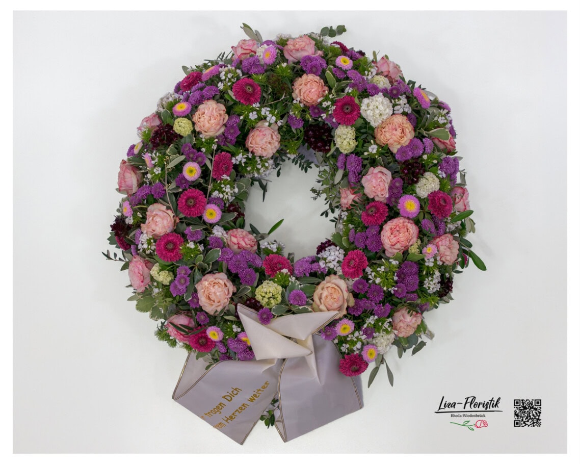Kondolenzkranz mit Rosen, Bartnelken, Gerbera, Santini und Astern in Rosa, Lila und Violett